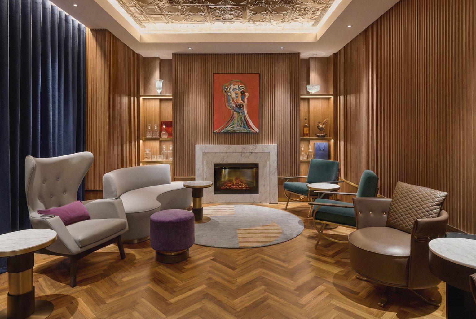 Elegant mid-century lounge with wood-paneled walls, fireplace, colorful artwork, plush chairs, and warm lighting creating a cozy atmosphere.